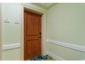 Hallway with wood paneled front door numbered 1204 and 1205 at 603 S Ocean Blvd. # 1205, North Myrtle Beach, SC 29582