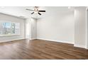 Bright and airy bedroom featuring hardwood floors and a large window offering natural light at 605 Carter Reid Ct., Longs, SC 29568