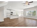 Spacious living area with hardwood floors, and an open layout connected to the kitchen area at 605 Carter Reid Ct., Longs, SC 29568