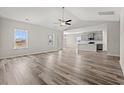 Open-concept living space with modern wood flooring and kitchen view at 609 Carter Reid Ct., Longs, SC 29568