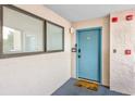 Condo 101 front door with a blue paint job, 