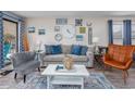 Comfortable living room with sofa, chairs, decorative art, and hardwood floors creating an inviting space at 7509 N Ocean Blvd. # 101, Myrtle Beach, SC 29572