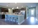 Modern kitchen island with seating, stainless steel appliances, and ample counter space at 860 Ireland Dr., Longs, SC 29568