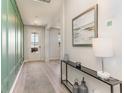 Welcoming entryway featuring stylish wall paneling, light wood floors, and modern decor at 867 Ireland Dr., Longs, SC 29568
