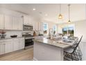 Bright kitchen with stainless appliances, granite countertops, and a view to the dining area at 867 Ireland Dr., Longs, SC 29568