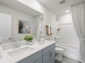 Modern bathroom featuring double sinks, gray cabinetry, and a shower-tub combination at 871 Cypress Preserve Circle, Longs, SC 29568