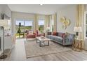 Comfortable living room with lake views, stylish furniture, and ample natural light at 871 Cypress Preserve Circle, Longs, SC 29568