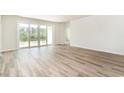 Spacious living room features wood-look floors and sliding glass doors to the backyard at 873 Ireland Dr., Longs, SC 29568