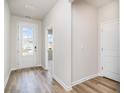 Inviting entryway with wood-look floors and a glass-paneled front door at 885 Ireland Dr., Longs, SC 29568
