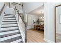 Bright entryway features hardwood floors and a staircase leading to the upper level at 890 Ireland Dr., Longs, SC 29568