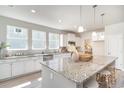 Bright kitchen features a large island with granite countertops and stainless steel appliances at 890 Ireland Dr., Longs, SC 29568