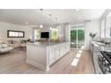 Open-concept kitchen showcases a large island, stainless steel appliances, and natural light at 890 Ireland Dr., Longs, SC 29568
