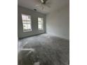 Bright bedroom featuring natural light from two windows and neutral walls and ceiling fan at 924 Morrall Dr., North Myrtle Beach, SC 29582