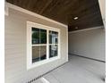 Cozy outdoor space with a stained wood ceiling, recessed lighting, and a view of the front yard at 924 Morrall Dr., North Myrtle Beach, SC 29582