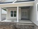 Inviting front porch featuring brick accents, stately columns, and double front doors at 924 Morrall Dr., North Myrtle Beach, SC 29582