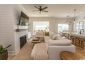 Open-concept living room featuring a cozy fireplace, plush seating, and stylish lighting at Simpson Creek Dr., Loris, SC 29569