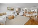 Bright, cozy living room features hardwood floors, white furniture, and stylish decor at 109 Pioneer Loop, Georgetown, SC 29440