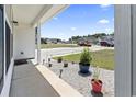 View from the front porch showcasing the front yard landscaping and the quiet, residential street at 109 Winding Path Dr., Loris, SC 29569