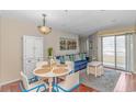 Comfortable living room and dining area, complete with a sliding glass door to the balcony at 1100 Possum Trot Rd. # H136, North Myrtle Beach, SC 29582