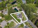 Beautiful aerial view highlighting lush and private backyard with in-ground pool, pond and wooded surround at 12 Gloucester Pl., Pawleys Island, SC 29585