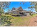 A well-maintained backyard with green grass and surrounding vegetation, offering privacy at 139 Chenoa Dr. # D, Murrells Inlet, SC 29576