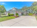 Front exterior featuring a brick facade, well-kept lawn, and a double driveway at 139 Chenoa Dr. # D, Murrells Inlet, SC 29576