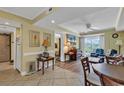 Comfortable living room featuring tile flooring, wood accents, ceiling fan, and access to an outdoor balcony at 14290 Ocean Hwy. # 210, Pawleys Island, SC 29585