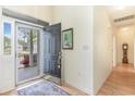 Inviting foyer showcasing an open door to a screened-in porch with hardwood floors at 1486 Medinah Ln., Murrells Inlet, SC 29576