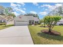 Charming single-story home featuring an attached two-car garage, mature landscaping, and inviting curb appeal at 1486 Medinah Ln., Murrells Inlet, SC 29576