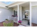 Welcoming front porch with seating and decorative touches, leading to the home's entrance at 1486 Medinah Ln., Murrells Inlet, SC 29576
