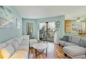 Bright living room featuring hardwood floors, light walls, and patio access at 1500 Cenith Dr. # F103, North Myrtle Beach, SC 29582