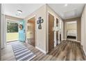 Bright foyer with new floors, coat closet, and an inviting blue front door adorned with a wreath at 153 Busbee St., Conway, SC 29526