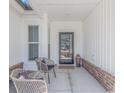 Inviting front porch featuring decorative chairs and decor, creating a cozy and welcoming entrance at 1546 Villena Dr., Myrtle Beach, SC 29579