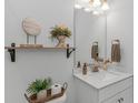 Stylish half bathroom with modern vanity, decorative shelving, and contemporary fixtures for guests at 1546 Villena Dr., Myrtle Beach, SC 29579