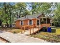 View of a single-story home featuring a ramp, surrounded by lush greenery at 1800 9Th Ave., Conway, SC 29527