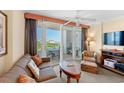 A cozy living area with large sliding doors opening onto a balcony at 215 77Th Ave. N # 807, Myrtle Beach, SC 29572