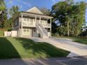 Inviting two-story home with a double porch, clean lines, and a spacious driveway at 223 S 9Th Ave. S, North Myrtle Beach, SC 29582
