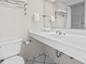 Bright bathroom featuring a wide mirror, a sink with fixtures, and a toilet for convenience and comfort at 2300 N Ocean Blvd. # 1430, Myrtle Beach, SC 29577