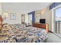 Comfortable bedroom featuring two beds, a dresser with a TV, and access to a private balcony with scenic views at 2300 N Ocean Blvd. # 1430, Myrtle Beach, SC 29577