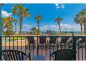 Relaxing poolside view with lounge chairs, palm trees, and clear blue skies at 2301 S Ocean Blvd. # 130, Myrtle Beach, SC 29577
