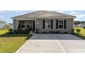 Attractive one-story home featuring neutral siding, well-maintained landscaping, and a driveway at 231 Jeff Waters Circle, Longs, SC 29568