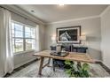 Office space with a large window, hardwood flooring, a wood desk, horse picture, and modern decor at 269 Mayflower Dr., Calabash, NC 28467