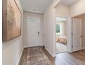 Bright foyer with wood floors and a decorative rug that leads into the bedroom and other living spaces at 2884 Riverboat Way, Conway, SC 29526