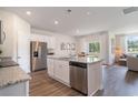 Modern kitchen with white cabinets, granite countertops, stainless steel appliances, and a center island at 2884 Riverboat Way, Conway, SC 29526