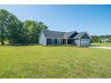 The front exterior of a blue single-story home with a well-maintained lawn at 294 Field Loop Rd., Georgetown, SC 29440