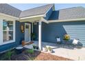 Cozy front porch with seating, potted plants, and a charming entrance at 294 Field Loop Rd., Georgetown, SC 29440