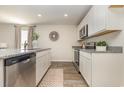 Modern kitchen featuring stainless steel appliances, granite countertops, and white cabinetry for a clean look at 296 Clear Lake Dr., Conway, SC 29526