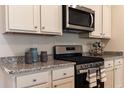 Modern kitchen features granite countertops, stainless steel appliances, and ample cabinet space for storage at 304 Clear Lake Dr., Conway, SC 29526