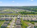 Aerial view of a residential neighborhood and the home, near a wooded area with a waterway and distant skyline at 3056 Skylar Dr., Myrtle Beach, SC 29577