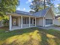 Inviting single-story home featuring a covered porch with classic white columns and an attached garage at 314 Trace Run, Myrtle Beach, SC 29588